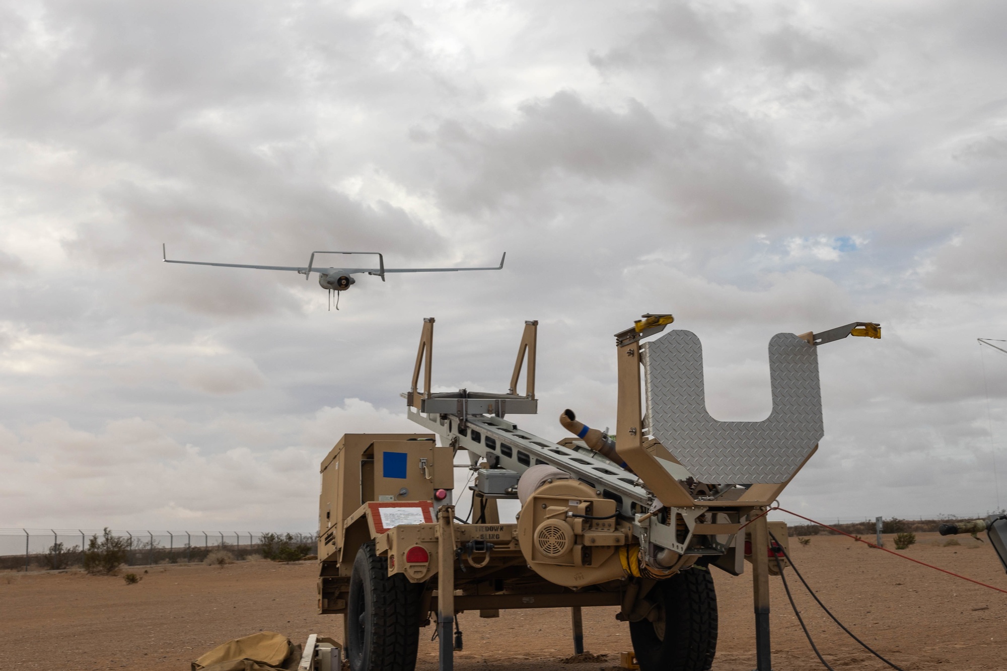 RQ-21A Blackjack rising from a mobile launcher beneath a cloudy sky