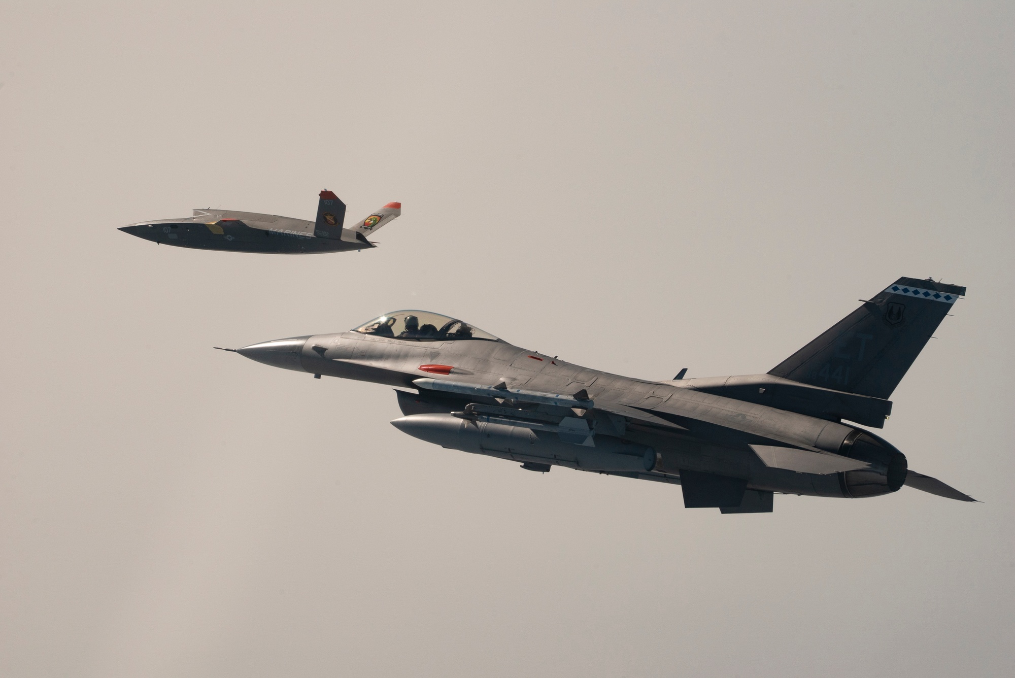 XQ-58A Valkyrie experimental UAV flying alongside an F-16